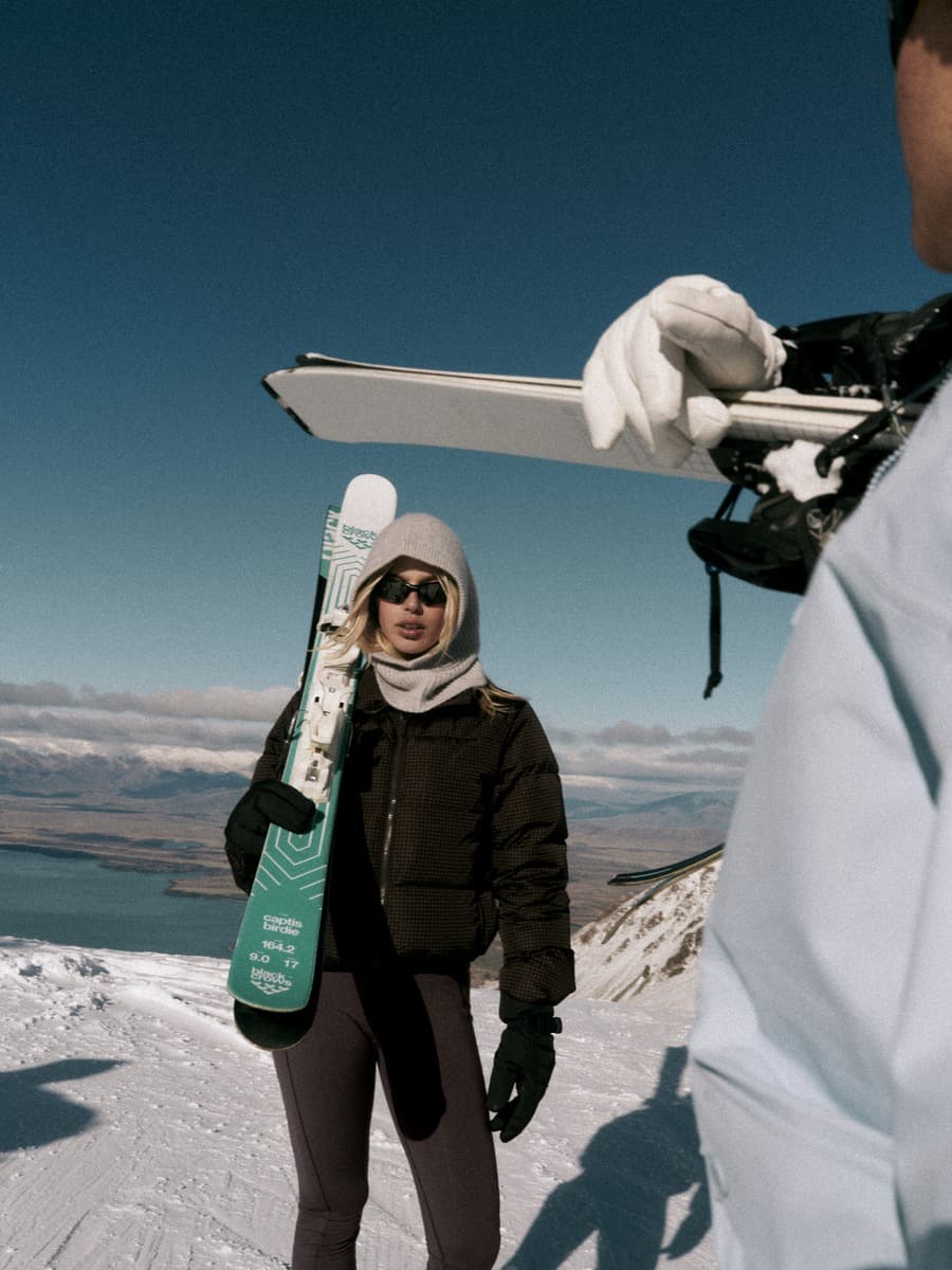 Vuori cold-weather layers styled with skis in the New Zealand mountains